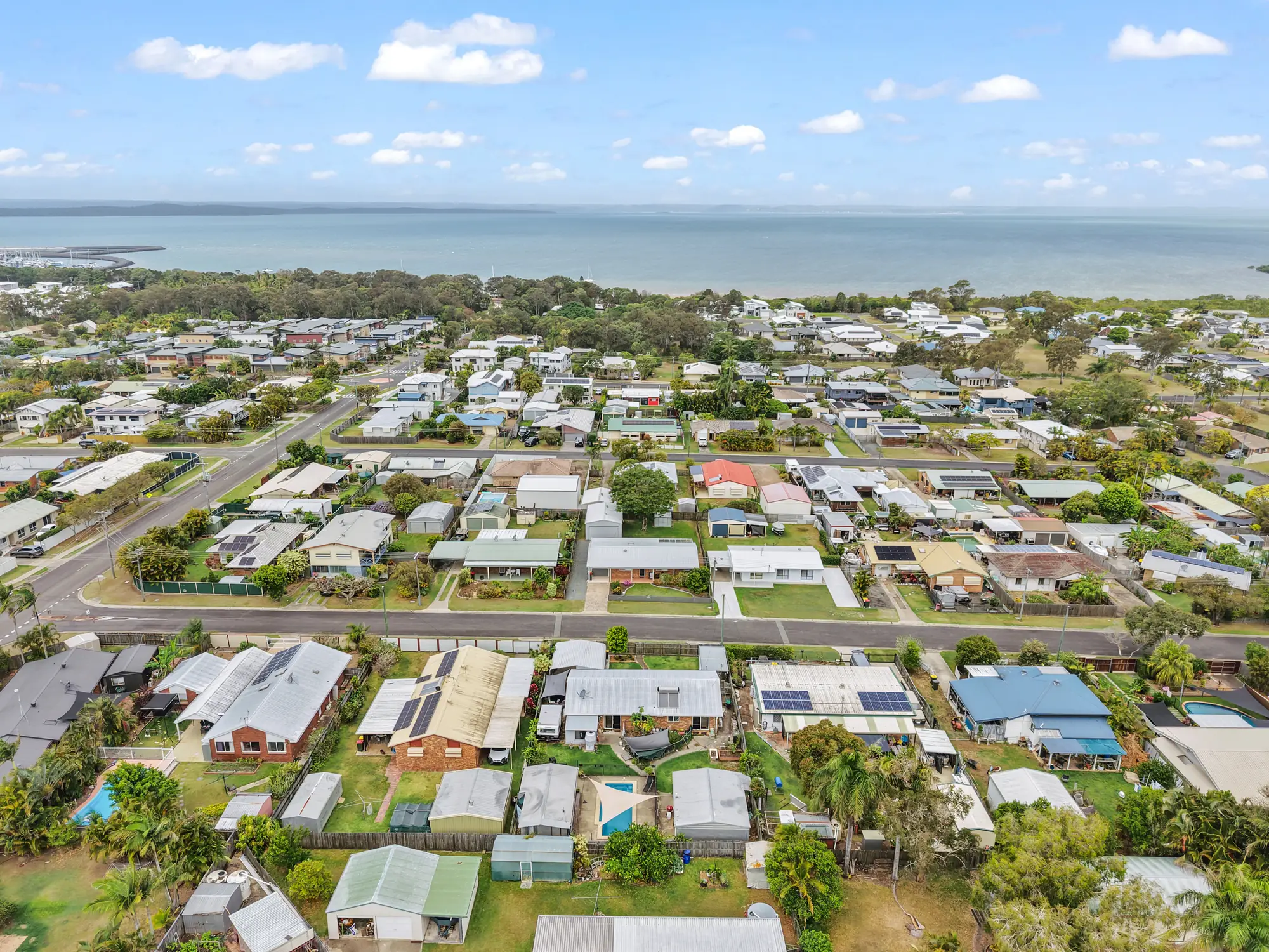 Aerial view over Urangan rooftops to Hervey Bay and the water